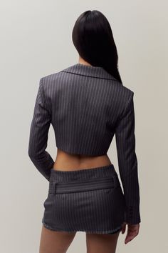 The Fei Pinstripe Cropped Blazer features a classic pinstripe pattern and a chic cropped length that offers a contemporary twist on a timeless design. Perfect for layering or wearing with the Andra Pinstripe Mini Skirt, it effortlessly elevates any outfit with its tailored fit and stylish appeal. Fabrication: Stretch Fine Twill; 65% Polyester, 30% Rayon, 5% Spandex Sonali is wearing a size S and is 5'10" with a 31" bust, 35" hips, and 23" waist Pinstripe Mini Skirt, Chic Mini Skirt, Pinstripe Pattern, Pinstriping Designs, Office Siren, Dressy Dresses, Lace Slip, Cropped Blazer, Eren Jaeger