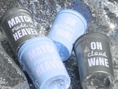 three plastic cups sitting on top of a cement floor next to each other with words written on them