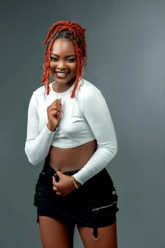 a woman with red dreadlocks posing for the camera