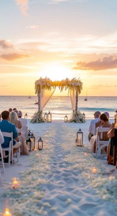 a wedding ceremony on the beach at sunset