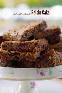 homemade raisin cake is stacked on top of each other in a white bowl with floral designs