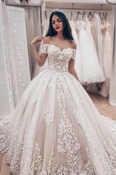 a woman wearing a wedding dress in a store