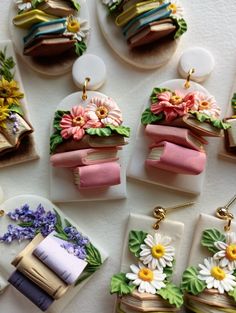 some miniature food items are laying out on the table with flowers and ribbons attached to them