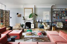 a living room filled with furniture and a fire place in the middle of a room