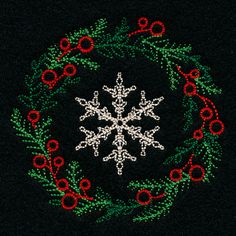 a snowflake is in the middle of a wreath with red berries and green leaves