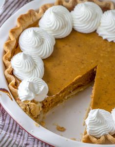 a pumpkin pie with whipped cream on top