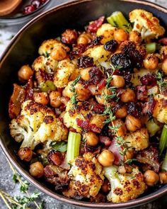 roasted cauliflower and chickpeas with cranberry sauce in a bowl