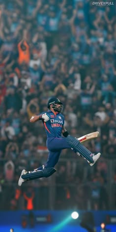 a cricket player is in mid air after hitting the ball