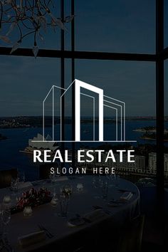 the logo for real estate is displayed in front of a window overlooking water and cityscape