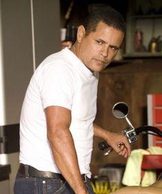 a man standing next to a parked motorcycle