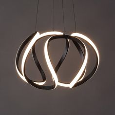 a circular light hanging from the ceiling with two lights attached to it's sides