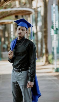 a man wearing a blue graduation cap and gown