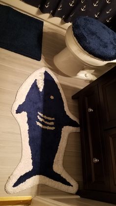 a bathroom with a blue rug on the floor