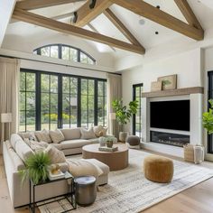 a living room filled with lots of furniture and a flat screen tv mounted on the wall