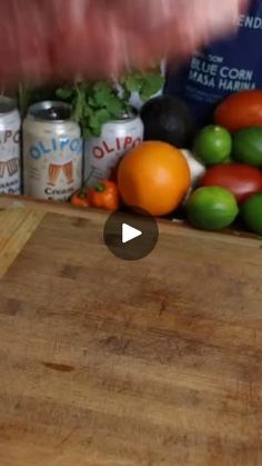 an image of a cutting board with fruits and vegetables in the background on a table