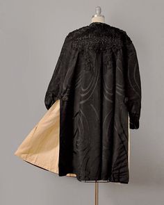 "This lavishly embellished statement coat hails from the late 1800's, and is made from the most extraordinary materials. The exterior is made from an incredible silk moiré jacquard -- with the signature grain effect of moiré, but with shimmery satiny swirls spread across its surface. The shoulders and chest are lavishly adorned with black gelatin sequins, real jet beading, heavy silk braid, and delicate net (with tiny hints of a spider's web motif). This exquisite hand-work cascades down the bac Elegant Silk Outerwear With Embroidery, Elegant Embroidered Silk Outerwear, Embroidered Silk Evening Outerwear, Silk Long Coat For Evening, Victorian Long Sleeve Evening Outerwear, Elegant Formal Outerwear With Historical Design, Elegant Embroidered Evening Outerwear, Victorian Jacket, Broadway Costumes