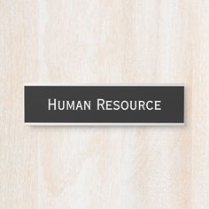 a black and white sign that says human resource on the side of a wooden wall