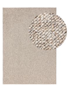 a beige rug with white pebbles on the bottom and an area rug in the middle