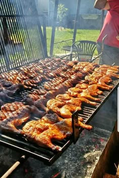 chicken and meat cooking on an outdoor grill