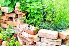 a garden wall made out of bricks and plants