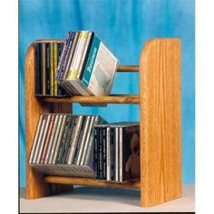 a wooden book shelf with cd's on it