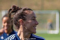 two female soccer players on the field during a practice session in preparation for their upcoming match