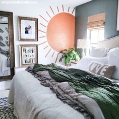 a large bed sitting in a bedroom next to two pictures on the wall above it