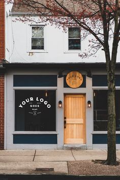 a store front with a wooden door and sign on the side of it that says your logo goes here