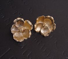 Mother Earrings, GOLD Magnolia Earrings, Stud Flower Earrings, Bridesmaid Gift Ideas, Mother Day from Daughter, Bridesmaid Earrings Beautiful set earrings of golden magnolia flower made of matte gold plated. These earrings come with .925 sterling silver post. Measurement Dimensions - 19.5mm These earrings are available in SILVER. Please leave a note at Check out if you want to purchase SILVER instead Matching Necklace https://www.etsy.com/listing/175334618/gold-magnolia-necklace-flower-pendant S Gold Flower Bridal Earrings For Anniversary, Nickel-free Gold Flower Earrings For Wedding, Gold Flower-shaped Earrings For Anniversary, Gold Flower-shaped Anniversary Earrings, Nickel-free Gold Clip-on Earrings For Weddings, Gold Flower Earrings For Bridesmaid Gift, Handmade Gold Earrings For Bridesmaid Gift, Handmade Gold Earrings For Bridesmaids, Vintage Gold Flower Earrings For Gift