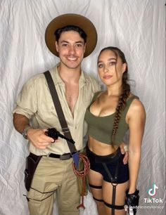 a man and woman dressed up as indiana jones and indiana jones from indiana jones, standing in front of a white backdrop