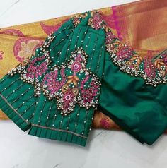 Peacock motifs inspired Maggam work blouse with Zari, Kundan, Beads and pearls work. This blouse can be made in any other color of your choice. Note - Doris and Latkans provided are complementary so please do not complain about them. We do our best to put best latkans for you. Disclaimer - Actual colors may vary slightly due to computer monitors displaying settings. We try hard to match exact color. For sizes 42+ we charge extra $20 for fabric and workmanship. Please contact us before placing or Traditional Green Blouse With Motifs, Designer Green Blouse With Motifs, Elegant Motif Blouse For Puja, Elegant Blouse With Motifs For Puja, Green Blouse With Mirror Work For Wedding, Green Wedding Blouse With Mirror Work, Green Handwork Saree Blouse Piece, Green Handwork Blouse For Wedding, Elegant Green Blouse With Motifs