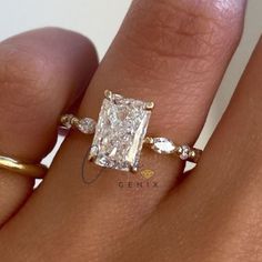 a woman's hand with a ring on it and a large diamond in the middle