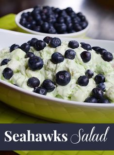 two bowls filled with food on top of a green table next to another bowl full of blueberries