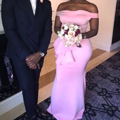 a man and woman in formal wear standing next to each other on a carpeted floor