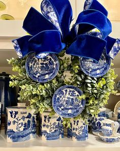 blue and white dishes are arranged on a shelf