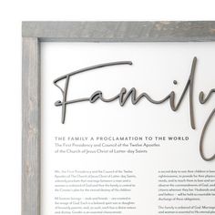 a family framed in a wooden frame with the word family on it's side