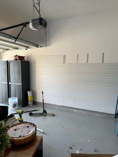 an empty garage with tools on the floor