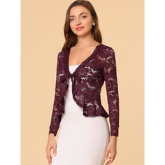 Opt for a decadent cover-up at your special occasion with this lace shrug. This stretchy lace cardigan gives the perfect balance to longer layers in a waist-defining cut with a tie front. A must-have in your clothing wardrobe. Constructed in a classic shrug silhouette, this charming piece benefits from an open neck and elegant long sleeves with ruffles. Intricate design details include satin binding around the front and hem and a floral lace design. Pair with a sleeveless dress, spaghetti strap, Spring Party Lace Shrug, Party Lace Shrug With Lace Sleeves, Party Shrug With Lace Trim, Sheer Shrug, Clothing Wardrobe, Lace Shrug, Bolero Shrug, Women's Tie, Lace Cardigan