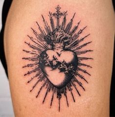 a black and white tattoo on the back of a woman's thigh with an image of a heart