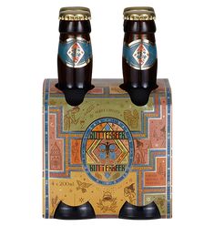 two bottles of beer sitting next to each other on top of a wooden box,