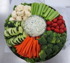 a platter filled with vegetables and dip