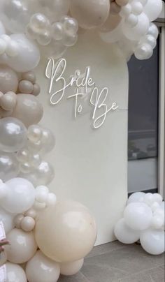 the bride to be sign is surrounded by balloons