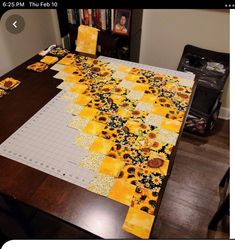 the table is covered with sunflowers and placemats on top of it