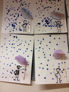 four handmade cards with pictures of people holding umbrellas in the rain and blue sprinkles on them