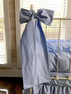 a blue bed with a bow on it