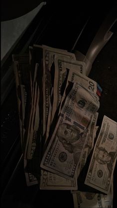 a pile of money sitting on top of a table next to a pair of scissors