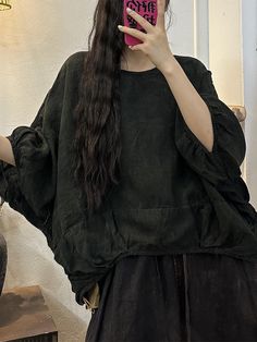 a woman taking a selfie in front of a mirror with her cell phone up to her ear