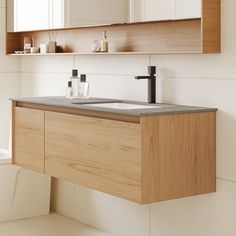 a bathroom with a sink, mirror and shelf above it