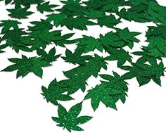 green glitter leaves are scattered on top of each other in the shape of an arrow