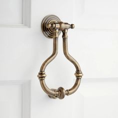 an antique brass door handle on a white door